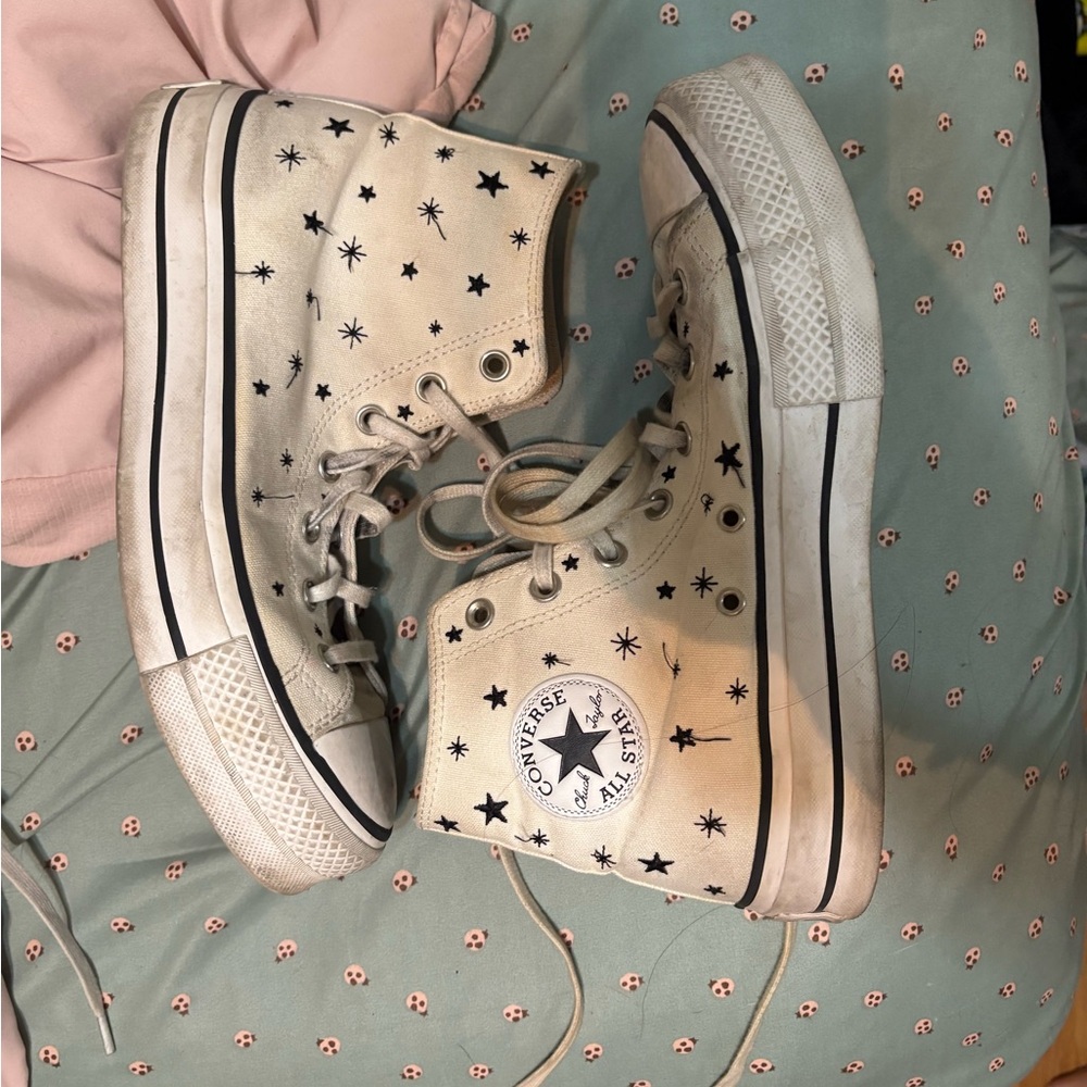 Converse Cream High Top Sneakers with Black Stars